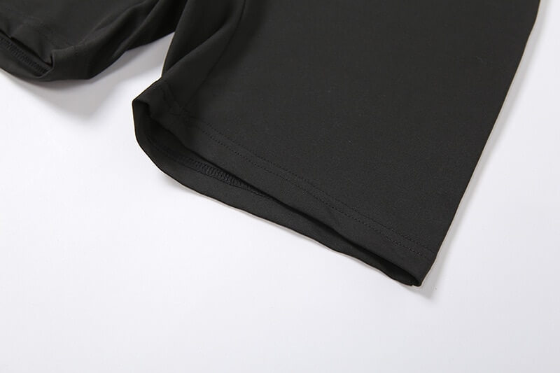 Close-up of black sports asymmetrical high-waist romper shorts, showcasing the sleek polyester-spandex fabric.